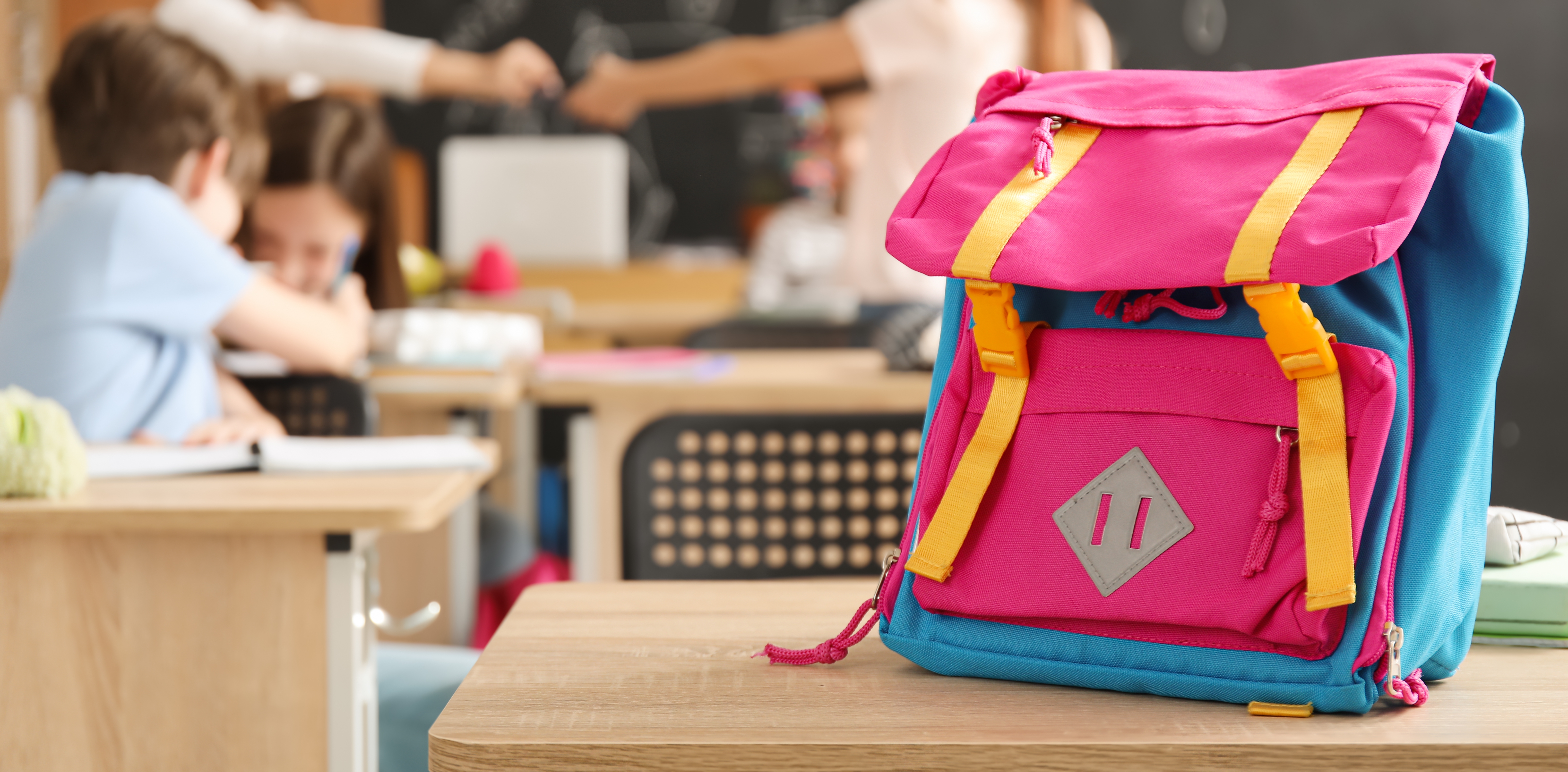 Child&apos;s,Backpack,On,Desk,In,Classroom