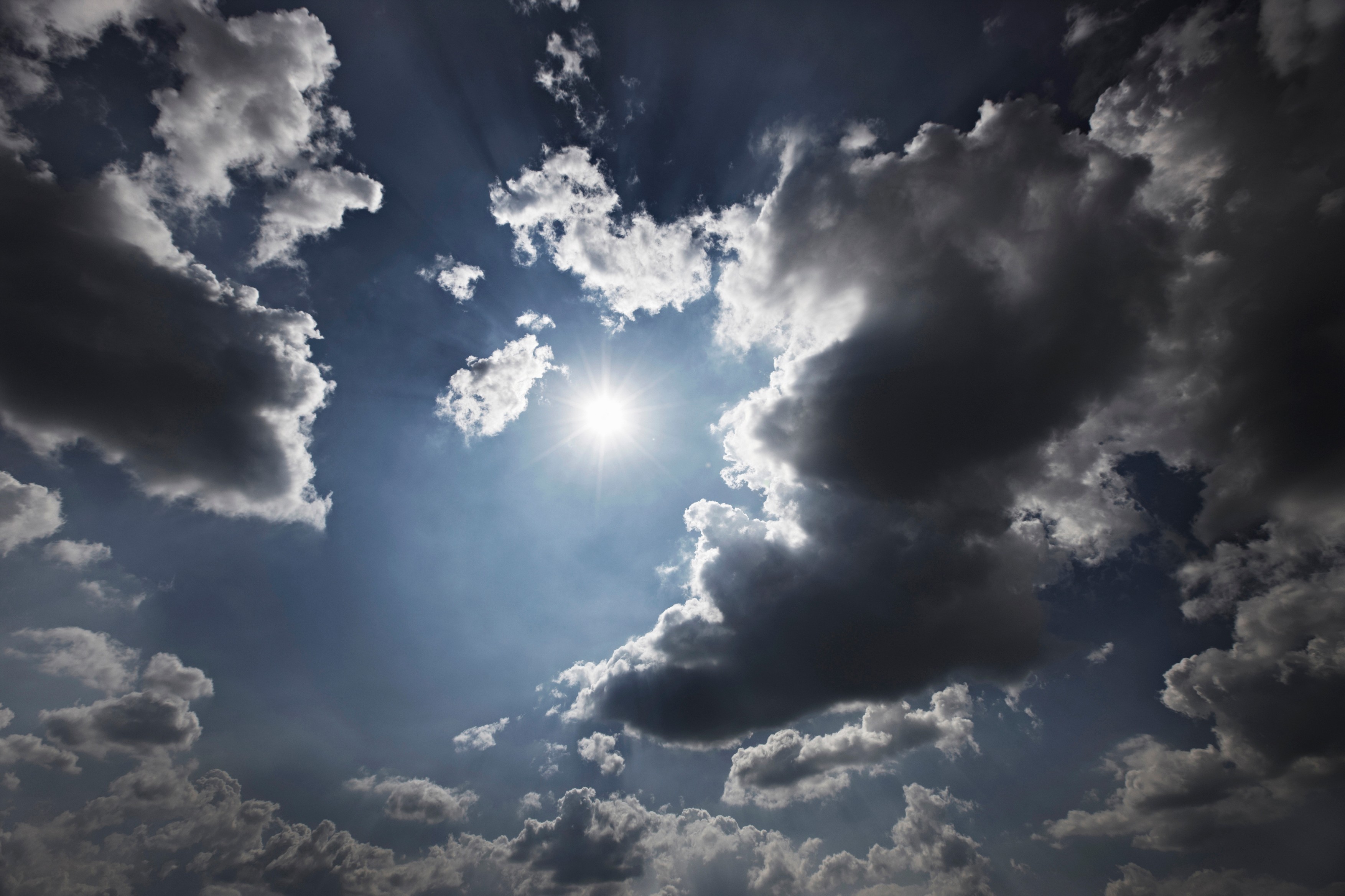 Sun and clouds in blue sky